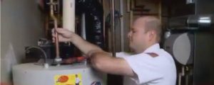 plumber servicing a water heater