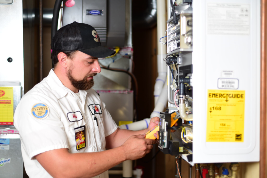 A Service Professor plumber repairing a tankless water heater.