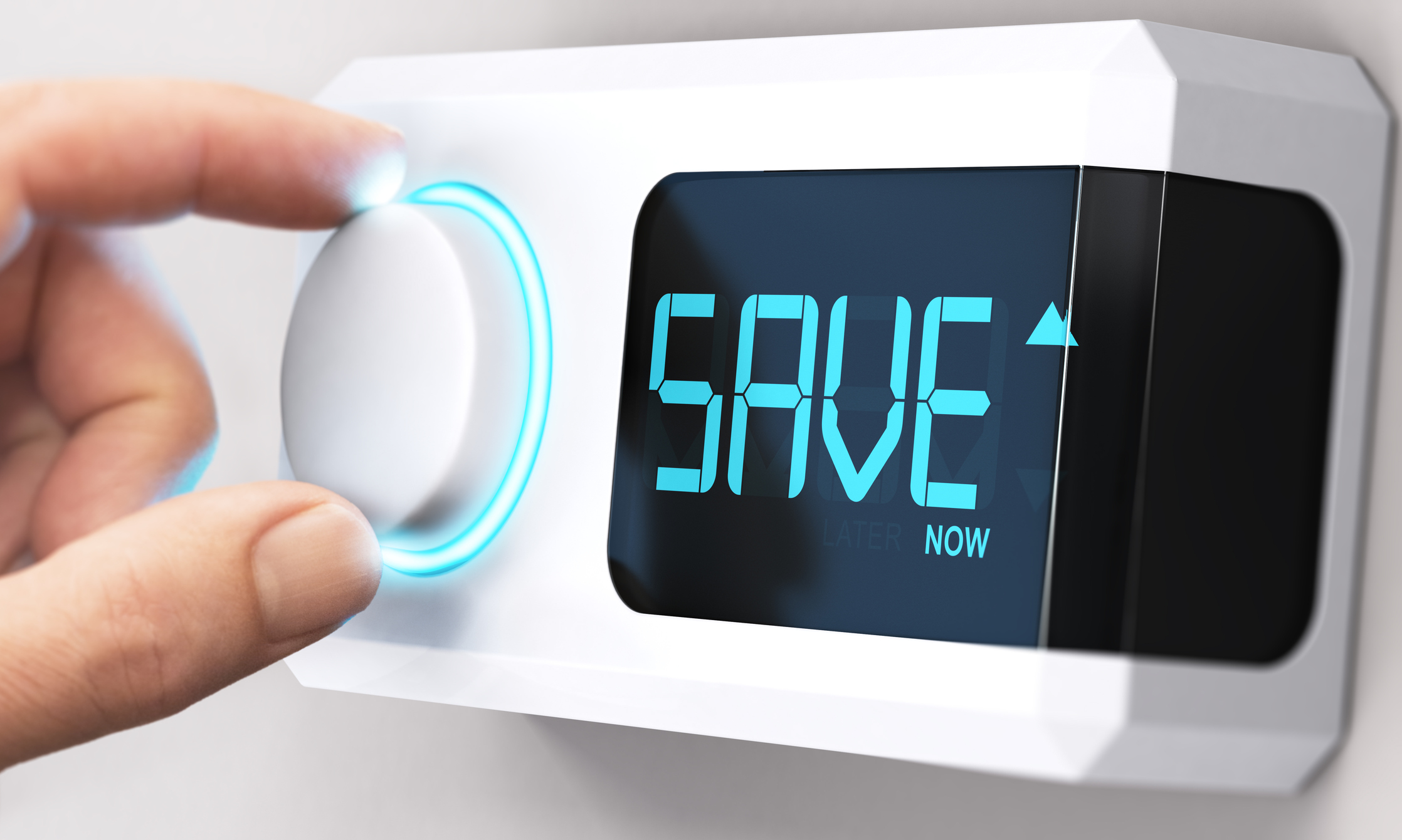 Close-up of a hand adjusting a knob on a white smart thermostat, with digital screen reading "SAVE now"