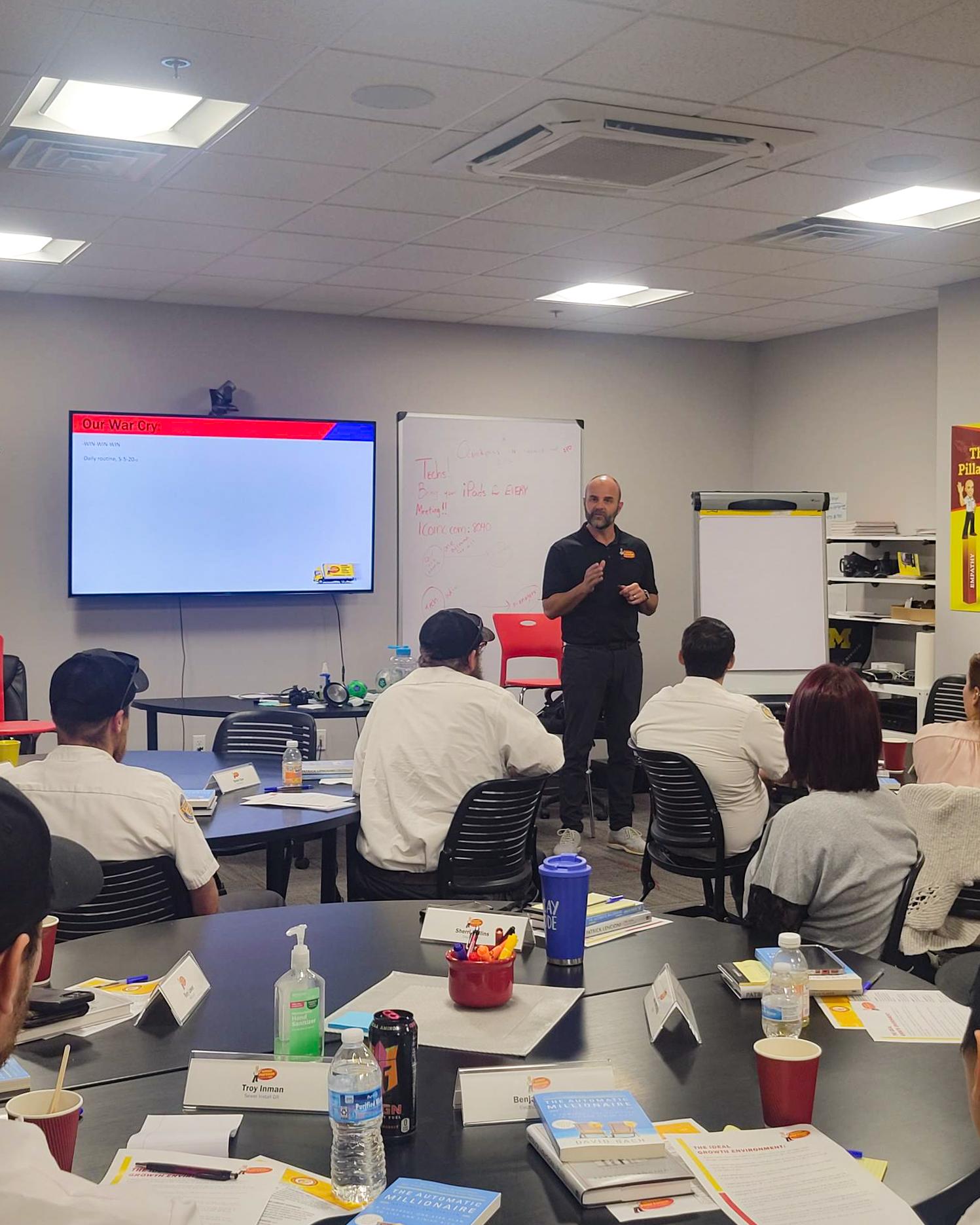 Inside the Service Professor training academy, a technician instructs a group of trainees.