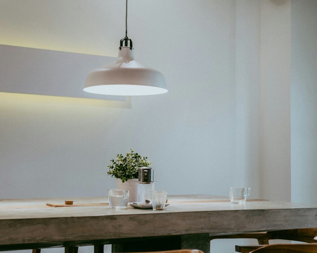 Hanging white pendant light over a kitchen table