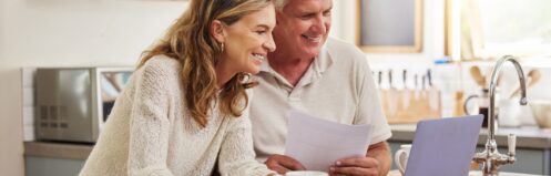 Couple looking at HVAC installation incentives and rebates on their laptop